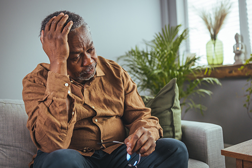 Man appearing distressed on couch