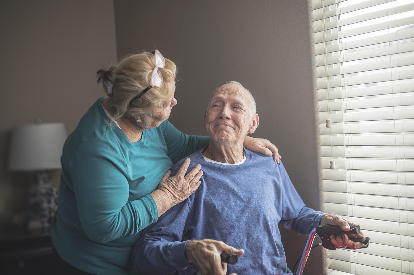 At Home Care Giver A caregiver provides support for an elderly man