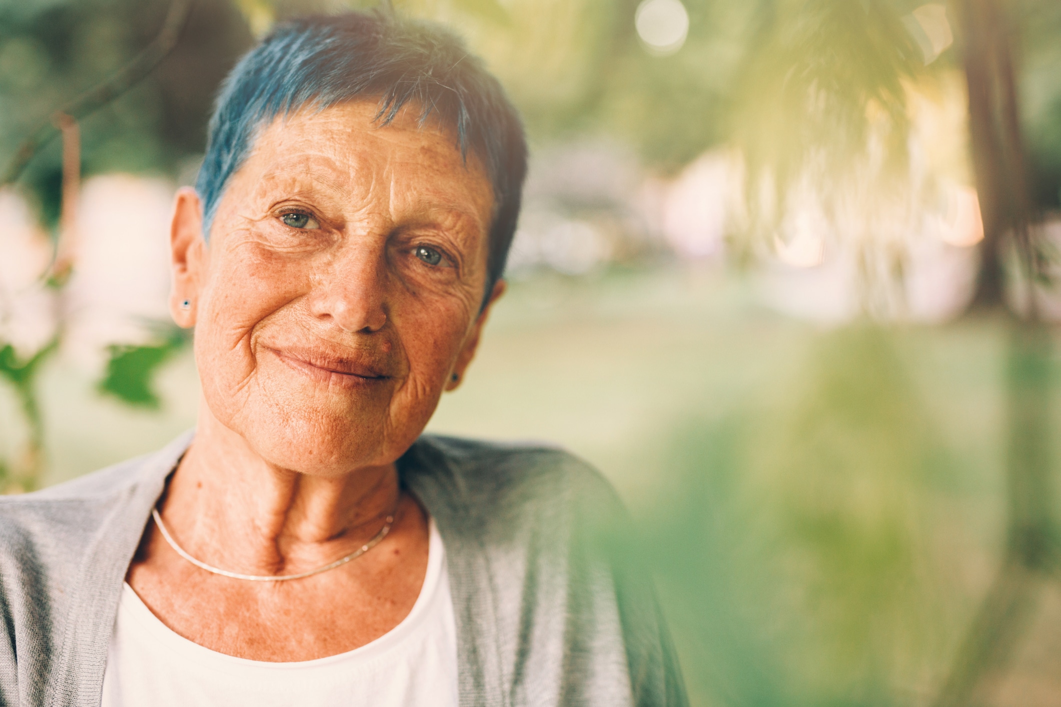 Portrait of a senior woman older woman staring out of a window